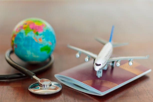 Planning medical tourism journey with a globe, passport, and stethoscope