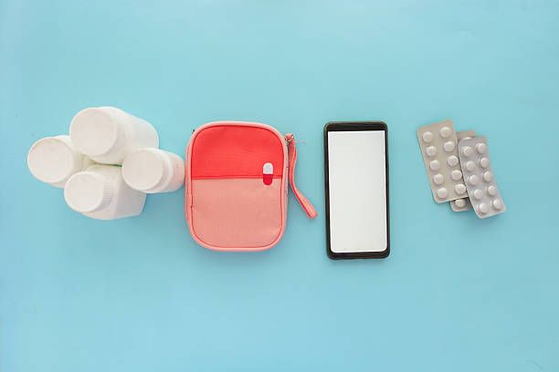 Modern travel health kit with smart gadgets, bandages, and digital health devices