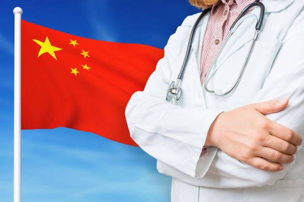 International medical student in China with Chinese flag backdrop
