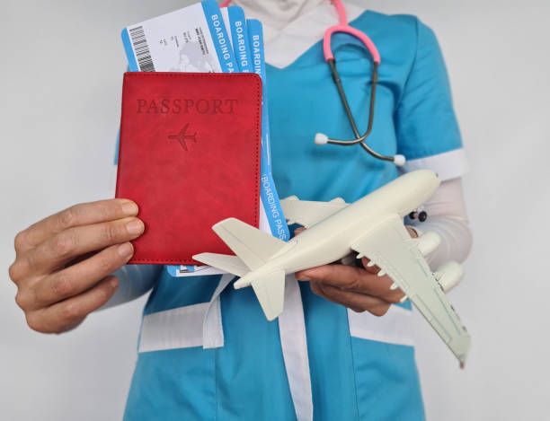 Doctor holding travel documents and medical insurance before boarding international flight.