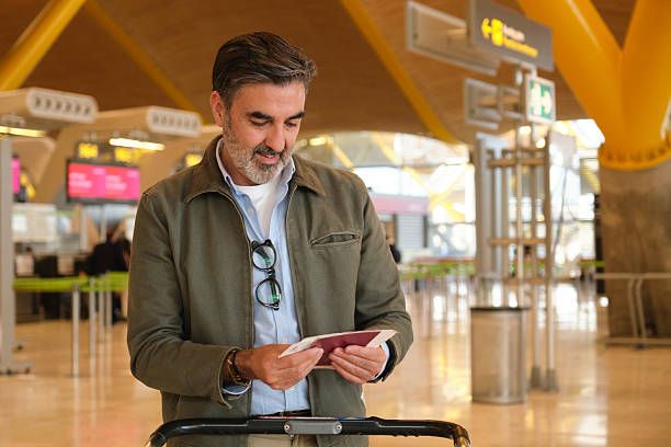 International traveler with travel insurance documents at airport terminal