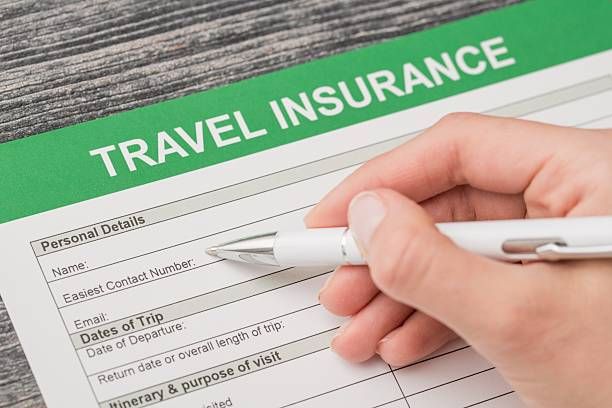 Traveler completing medical travel insurance form before departure